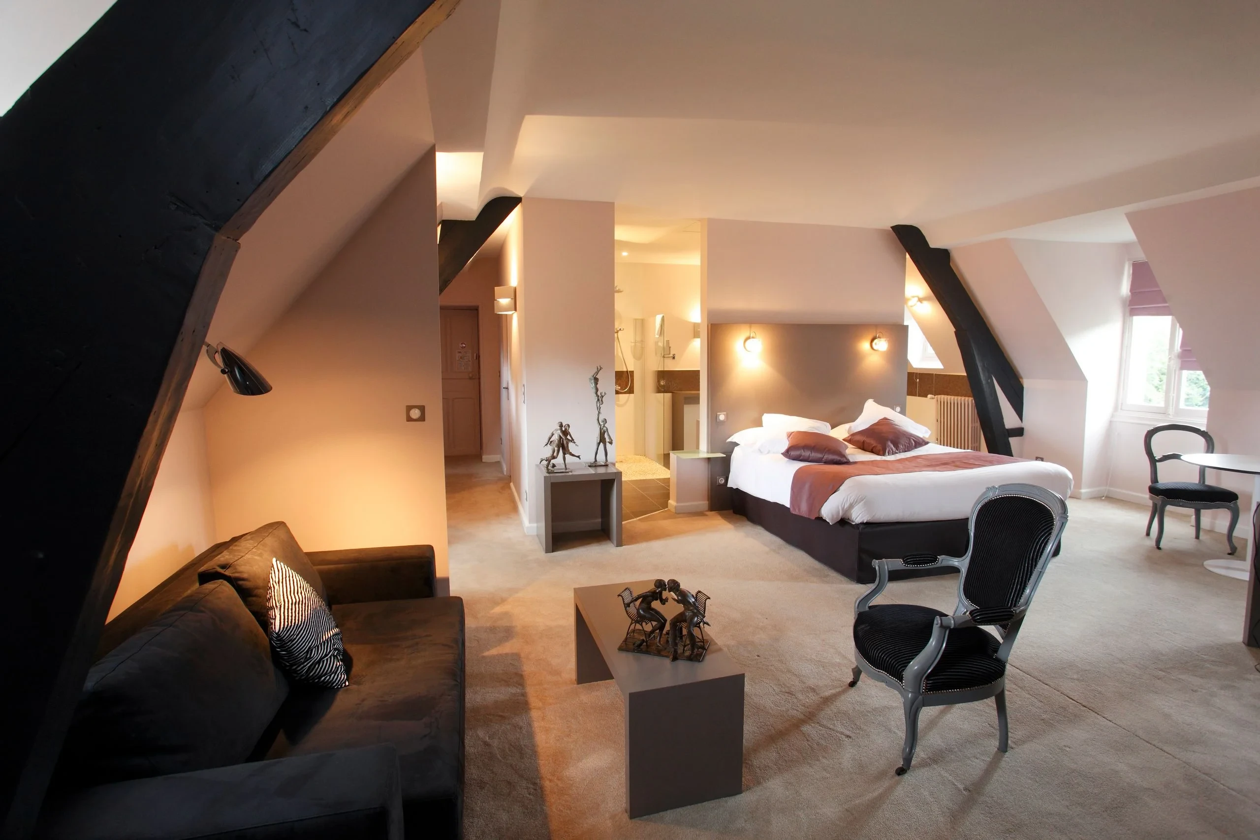 Chambre mansardée moderne avec poutres apparentes